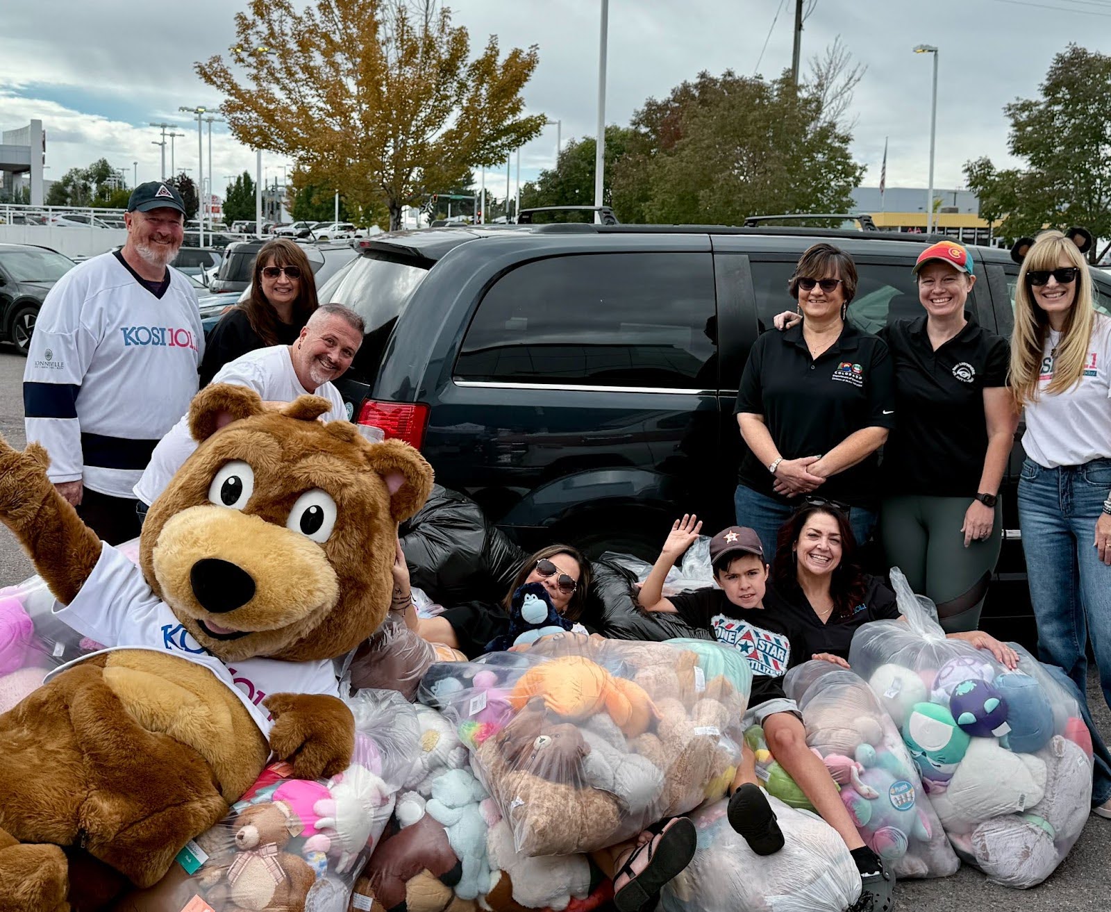 DMV and KOSI 101.1 staff pose with donations