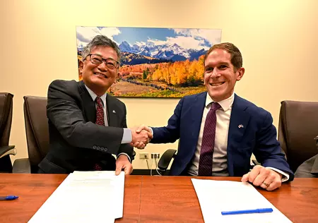 Consul General Yoichi Mikami, of the Consulate-General of Japan in Denver, and Colorado Department of Revenue Executive Director Mark Ferrandino shake hands after signing a reciprocity agreement on Monday, April 24, 2023 at CDOR’s main office in Lakewood. They signed a memorandum of cooperation that enables those with valid Japan or Colorado driver licenses, who meet all other requirements, to obtain a driver license in the corresponding country without having to take the driving or written tests. (Derek Ku