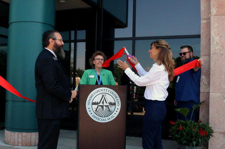 Adams County Clerk & Recorder Josh Zygielbaum, left, and Colorado Division of Motor Vehicles Senior Director Electra Bustle cut the ribbon Monday, July 31, 2023 for the new state driver license office at the Adams County Western Services Center at 12200 Pecos St. in Westminster. The new partnership is a gamechanger, offering Adams County residents a one-stop DMV experience while providing a new place for all Coloradans to get driver licenses and identification cards. (Julie Jackson/Adams County Government)