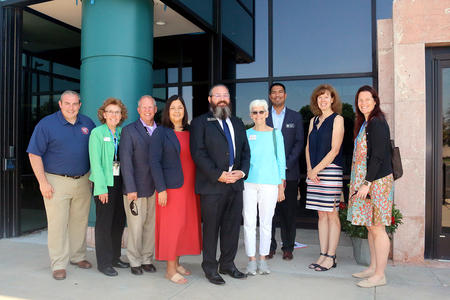 Adams County Clerk & Recorder and Colorado Division of Motor Vehicles staff members smile for a photo after cutting the ribbon Monday, July 31, 2023 for the new state driver license office at the Adams County Western Services Center at 12200 Pecos St. in Westminster. The new partnership is a gamechanger, offering Adams County residents a one-stop DMV experience while providing a new place for all Coloradans to get driver licenses and identification cards. (Julie Jackson/Adams County Government)