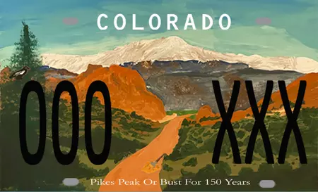 License plate of Pikes Peak in the background and Garden of the Gods in the foreground, green rolling hills with an Evergreen street and a red clay road through the center.