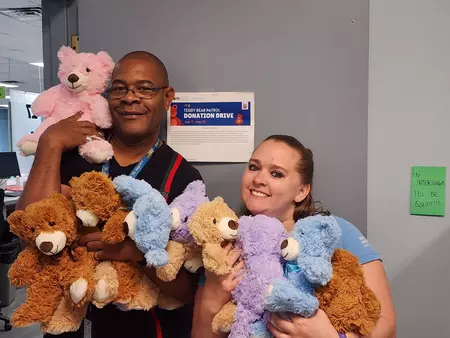 Aurora Driver License Team Members smile while holding up one of the stuffed animals the office collected for the KOSI 101.1 Teddy Bear Patrol Donation Drive. The DMV collected 79 new stuffed animals throughout August in support of the effort. The stuffed animals are for first responders and hospital staff to give to comfort children experiencing a traumatic event.