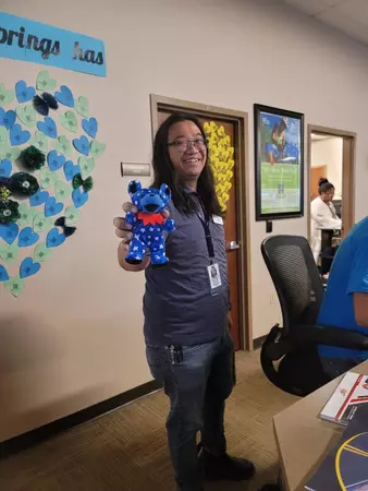 A Colorado Springs Driver License Team Member smiles while holding up one of the stuffed animals the office collected for the KOSI 101.1 Teddy Bear Patrol Donation Drive.. The DMV collected 79 new stuffed animals throughout August in support of the effort. The stuffed animals are for first responders and hospital staff to give to comfort children experiencing a traumatic event. 