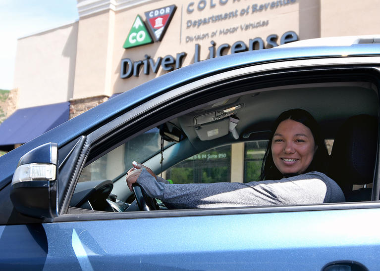  A DMV Team Member at the wheel of her car